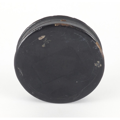 35 - 19th century circular Papier-mâché snuff box, the lid hand painted with a figure drinking, 8.5cm in ... 