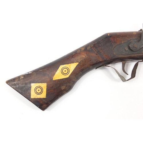 583 - Indian flint lock rifle with bone inlay and a similar pistol, the largest 160cm in length