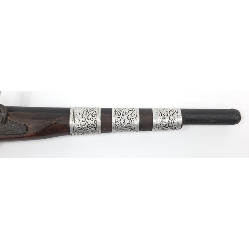 583 - Indian flint lock rifle with bone inlay and a similar pistol, the largest 160cm in length