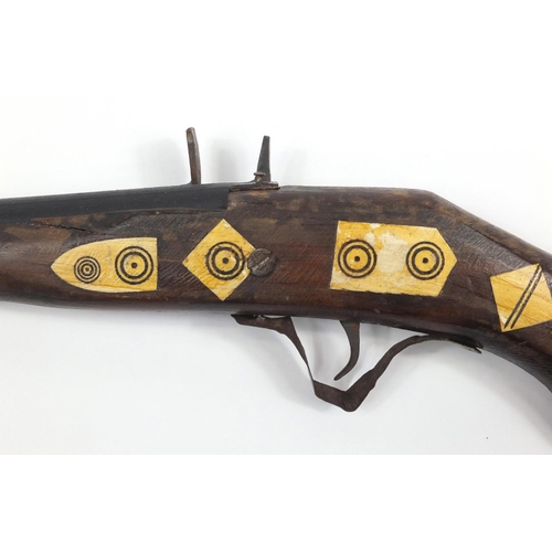 583 - Indian flint lock rifle with bone inlay and a similar pistol, the largest 160cm in length