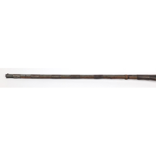 583 - Indian flint lock rifle with bone inlay and a similar pistol, the largest 160cm in length