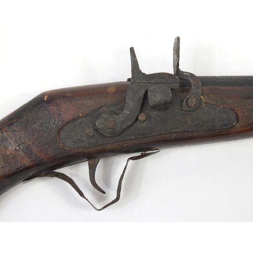 583 - Indian flint lock rifle with bone inlay and a similar pistol, the largest 160cm in length