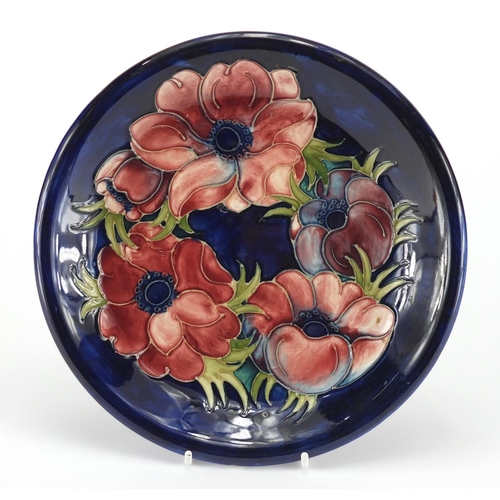 949 - Moorcroft Poppy pattern pottery plate, impressed factory marks to the base, 22cm in diameter