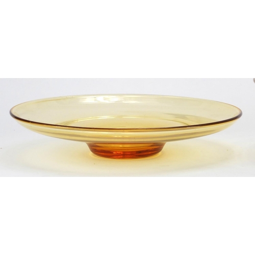 938 - Two Whitefriars tangerine glass dishes including a footed ribbon example designed by Tom Hill, the l... 