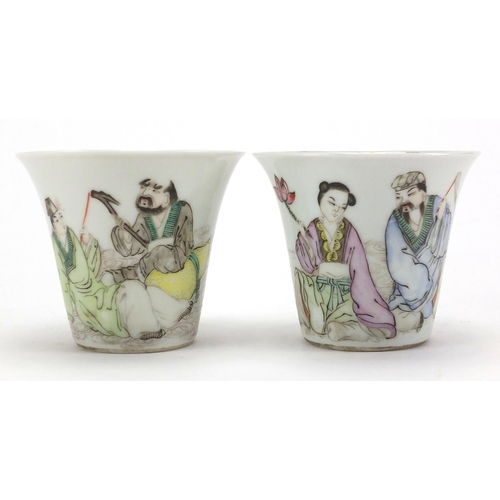 633 - Pair of Chinese porcelain fluted tea cups, each hand painted in the famille rose palette with two fi... 