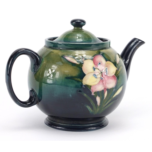 945 - Moorcroft Freesia pattern pottery teapot, hand painted and impressed factory marks to the base, 15.5... 