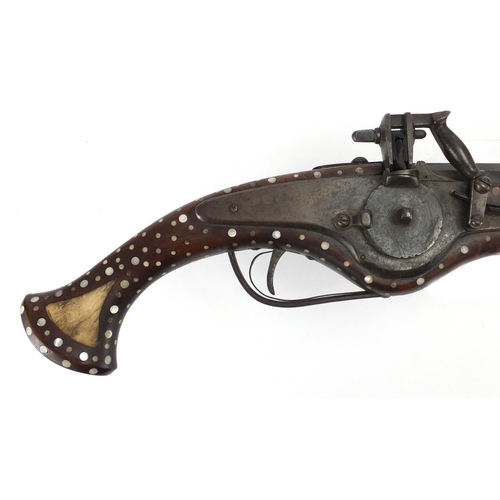 582 - Antique wheel-lock pistol with octagonal barrel, inlaid with bone and Mother of Pearl, 65cm in lengt... 