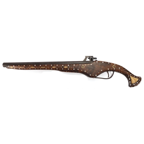 582 - Antique wheel-lock pistol with octagonal barrel, inlaid with bone and Mother of Pearl, 65cm in lengt... 