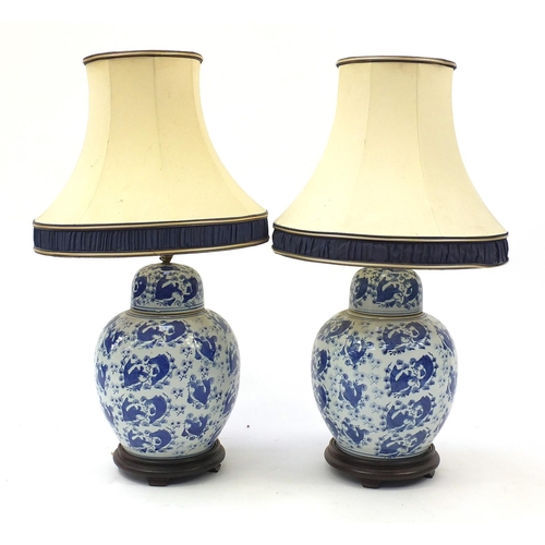 2031 - Pair of Chinese blue and white porcelain jar lamps hand painted with fish, each with a silk lined be... 