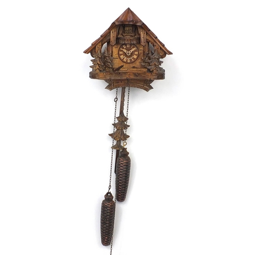 2030 - Black Forest wooden cuckoo clock carved with trees, with pendulum and weights, the clock 22cm high