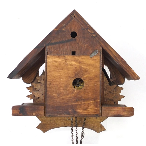 2030 - Black Forest wooden cuckoo clock carved with trees, with pendulum and weights, the clock 22cm high