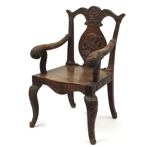 2007 - Chinese hardwood elbow chair profusely carved with dragons, 99cm high