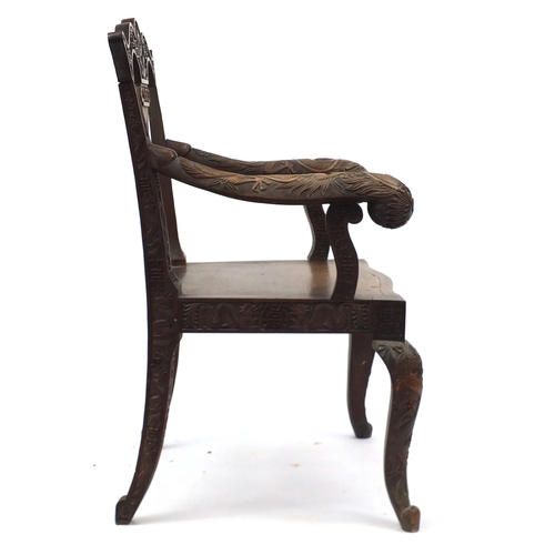 2007 - Chinese hardwood elbow chair profusely carved with dragons, 99cm high