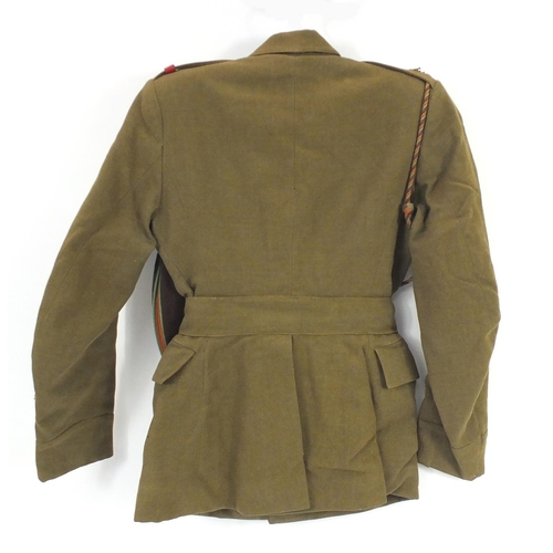 603 - Child's Military interest tunic and cap, with brass badges and buttons