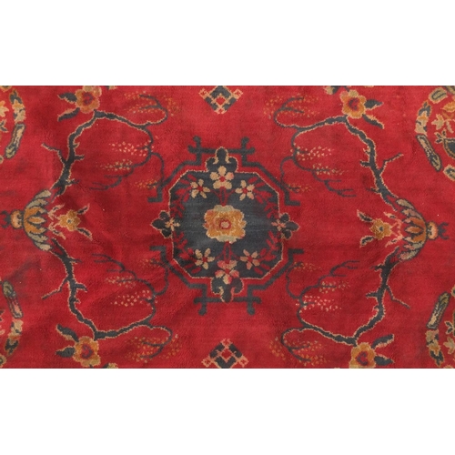2004 - Early Chinese Tibetan rug, having a floral design onto a red ground, 178cm x 130cm