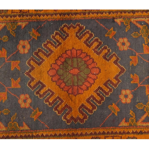 2005 - Rectangular Turkish Oushak carpet runner, having a floral design onto a orange and blue ground, 320c... 