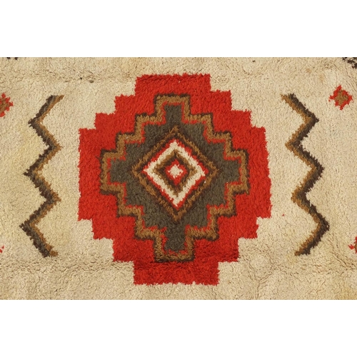 2051 - Rectangular Moroccan Berber rug, having a geometric design onto a cream and green ground, 296cm x 20... 