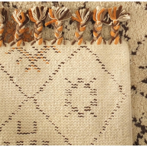 2027 - Rectangular Moroccan Berber rug, having a geometric design onto a predominantly cream ground, 296cm ... 