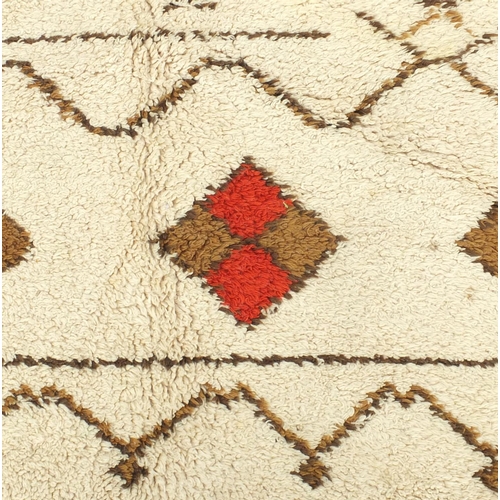 2010 - Rectangular Moroccan Berber carpet, having a geometric design onto a cream ground, 395cm x 305cm