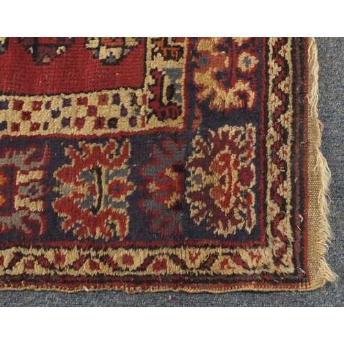 2052 - Rectangular Persian rug having and all over flower head and geometric design, 187cm x 96cm