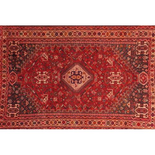 2011 - Rectangular Persian Qashqai rug, having an all over stylised design onto a red ground, 253cm x 178cm
