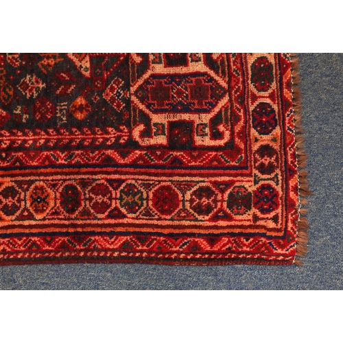 2011 - Rectangular Persian Qashqai rug, having an all over stylised design onto a red ground, 253cm x 178cm