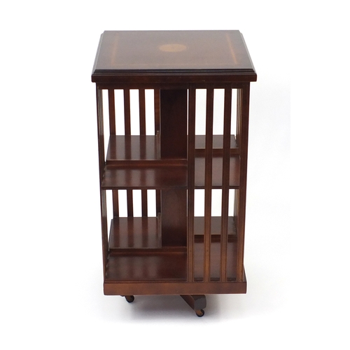 24 - Inlaid mahogany revolving bookcase, 86cm H x 46cm W x 46cm D
