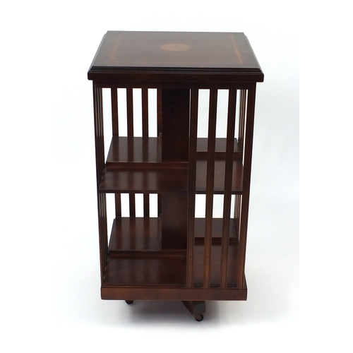 24 - Inlaid mahogany revolving bookcase, 86cm H x 46cm W x 46cm D