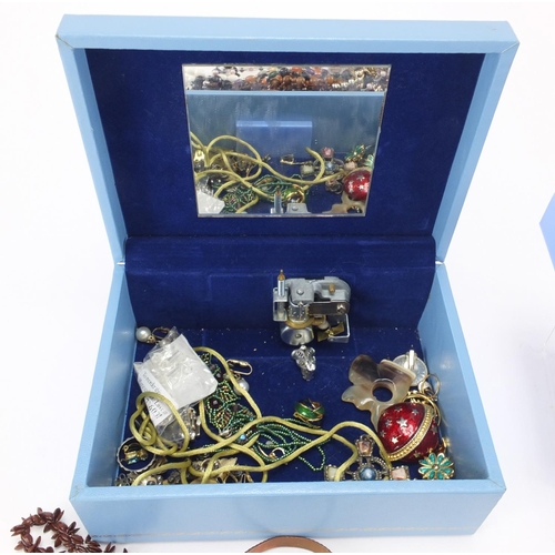 338 - Costume jewellery including some silver, housed in a musical jewellery box