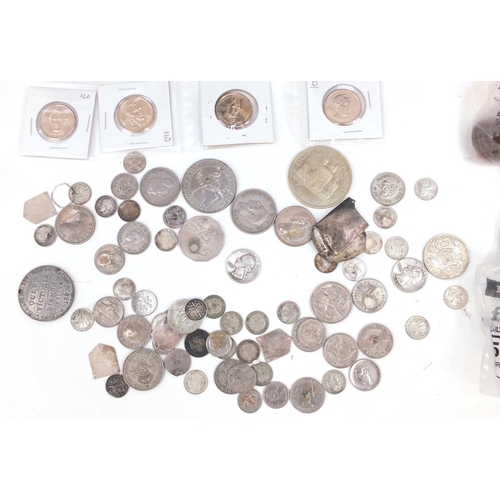 645 - British and World coinage including some silver, housed in a black tin