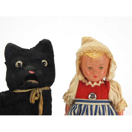 402 - Vintage clockwork toy cat and a composite Dutch girl doll, the cat 15cm high