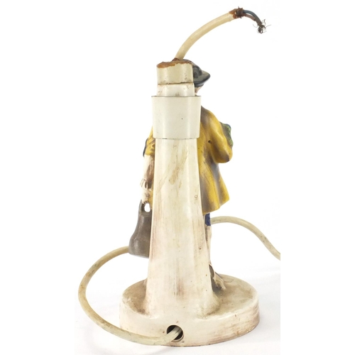 509 - Goebel  porcelain table lamp, in the form of a young figure holding a watering can and bunch of flow... 