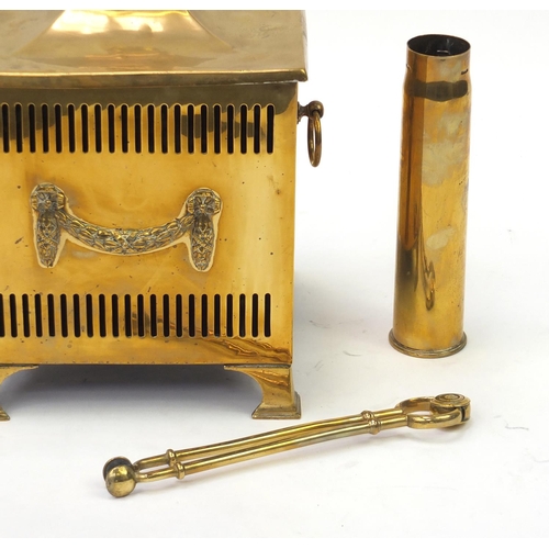 706 - Brass coal box and cover, with fire tools, shell case and two car radiator badges