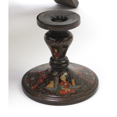 112 - Hand painted cashmere bookrest and candlestick, the bookrest 41cm high