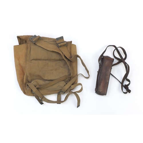 917 - Military interest canvas rucksack and leather holster, with impressed marks date 1940