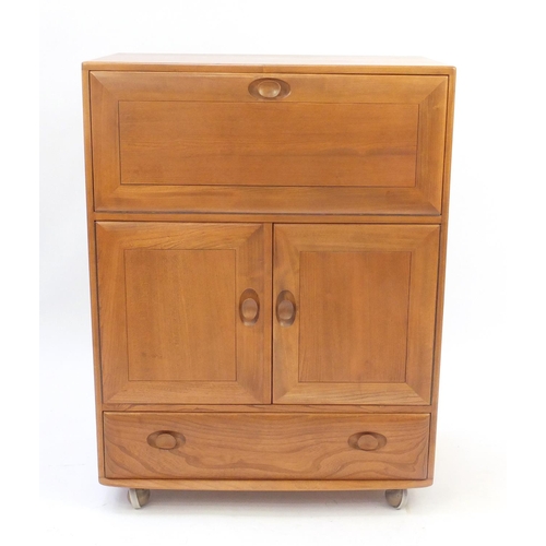 2011 - Ercol light elm side cabinet, fitted with a fall above a pair of cupboard doors and base drawer, 110... 