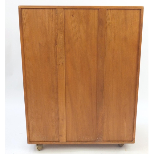 2011 - Ercol light elm side cabinet, fitted with a fall above a pair of cupboard doors and base drawer, 110... 