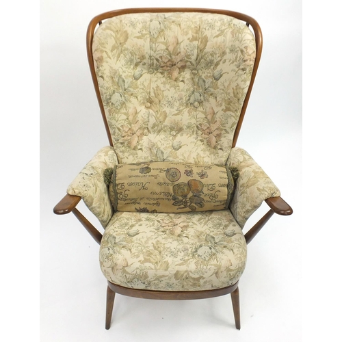 2024 - Ercol elm stick back armchair, with floral button back upholstery, 105cm high