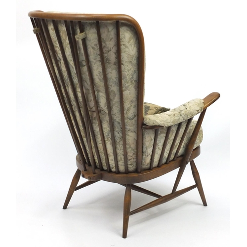 2024 - Ercol elm stick back armchair, with floral button back upholstery, 105cm high