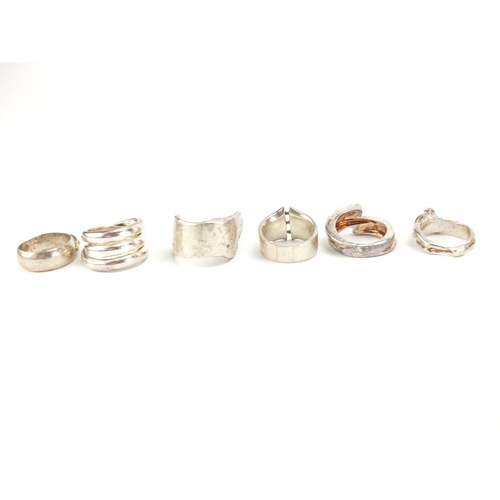 288 - Six silver and white metal rings, some set with stones and an erotic example, various sizes, approxi... 