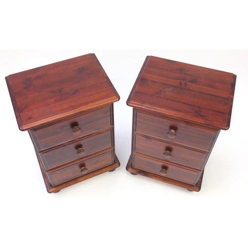 100 - Pair of stained pine three drawer bedside chests, 64cm H x 44cm W x 34cm D