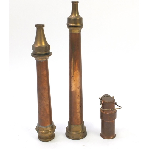 768 - Two fire hose nozzles and a Barnsley Yorks copper and brass lamp