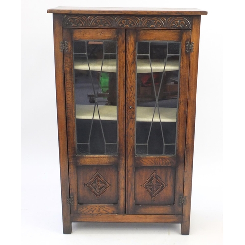 8 - Oak bookcase fitted with a pair of leaded glass doors, 122cm H x 75cm W x 29cm D