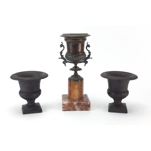 158 - Pair of cast iron urn shaped planters and a bronzed example with faux marble base, the largest 28cm ... 