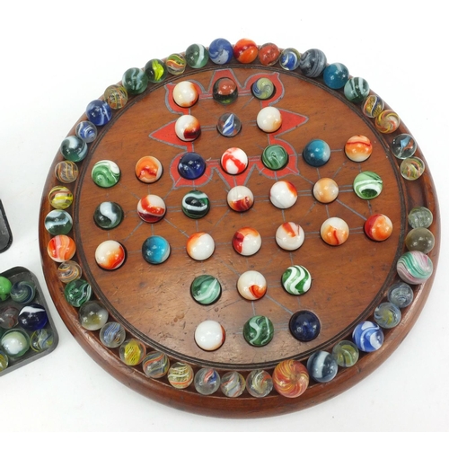 508 - Victorian and later glass marbles, with a turned wooden solitaire board