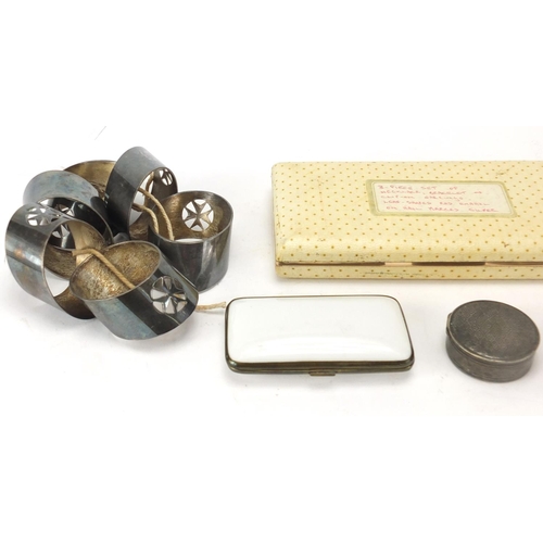 466 - Objects including silver coloured metal napkin rings, cigarette cases and a pill box