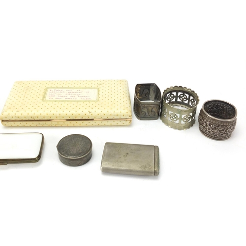 466 - Objects including silver coloured metal napkin rings, cigarette cases and a pill box