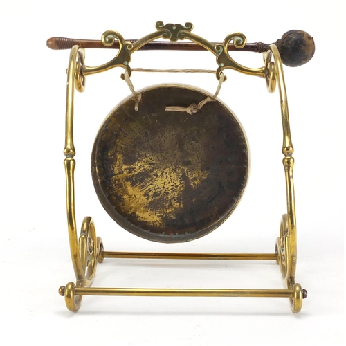 134 - Brass table gong, 22cm high