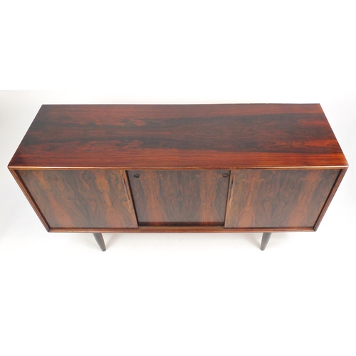 2003 - Vintage Danish rosewood sideboard fitted with three sliding drawers enclosing shelves and drawers,  ... 