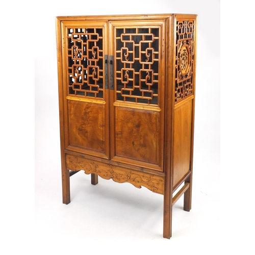 2016 - Oriental hardwood cabinet fitted with fretwork doors, enclosing two open shelves and drawers, 167cm ... 